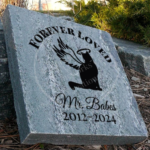 Engraved personalized granite pet memorial marker accent stone feature with "Forever Loved" and cat, halo, wings placed outside.
