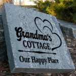 Engraved granite grandma's cottage stone with two hearts design that says our happy place.