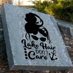 Engraved granite cottage stone with woman with messy hair and sunglasses design that says lake hair don't care.
